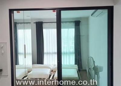 Bedroom with glass sliding doors and double bed