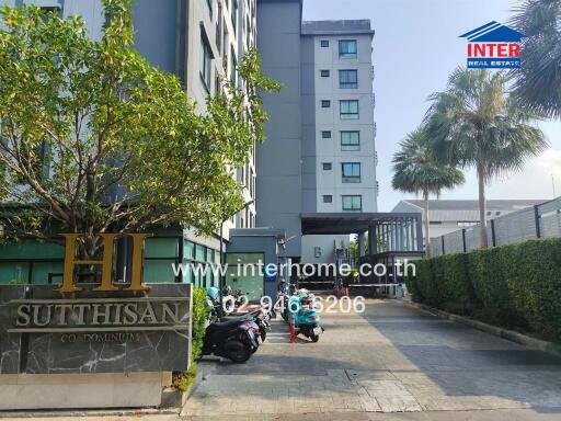 Condominium building exterior with entrance and parked motorbikes