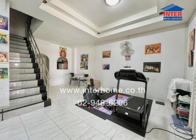 Main living space with treadmill and dining area