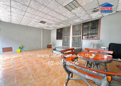 Spacious patio area with tiled floor and seating