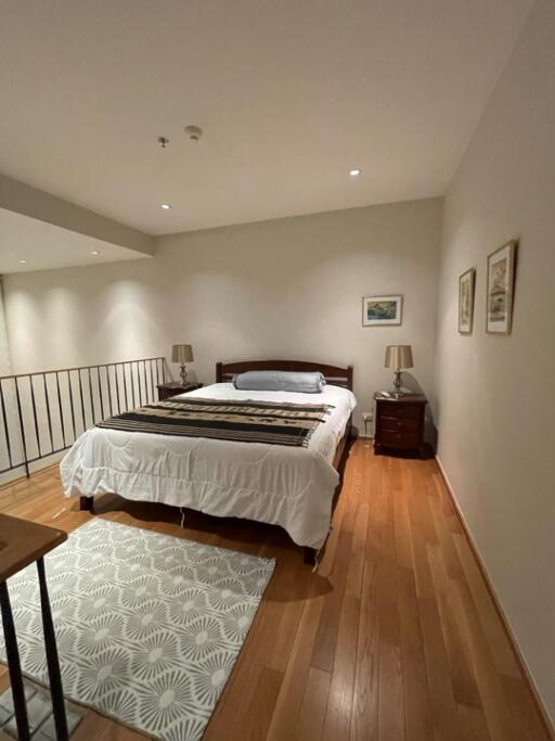 cozy bedroom with wooden floor and double bed