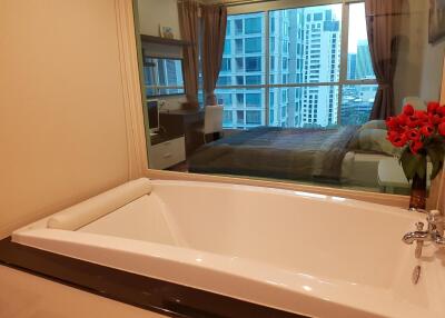 Bathroom with a bathtub and view of a bedroom