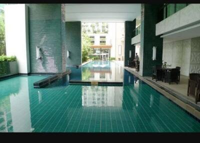 Indoor swimming pool with seating area