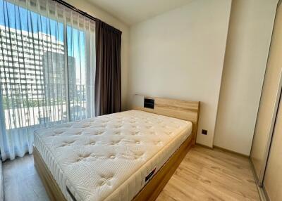 Bedroom with large window and bed