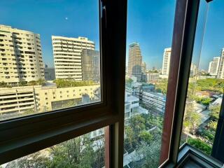 View of the cityscape through a window in a high-rise building