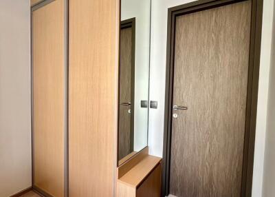 Modern entryway with wooden wardrobe and mirror