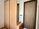 Modern entryway with wooden wardrobe and mirror