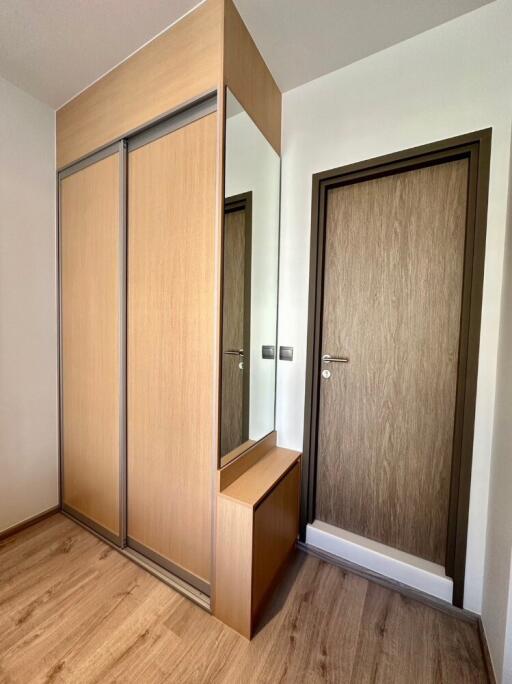 Modern entryway with wooden wardrobe and mirror