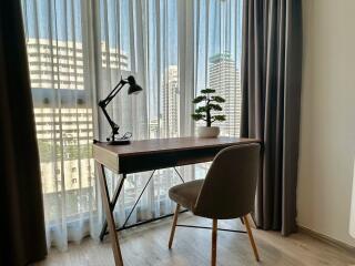 Cozy home office with a view of city buildings