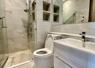 Modern bathroom with shower, toilet, and sink