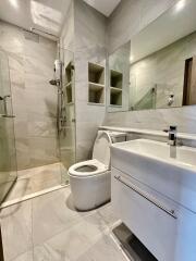 Modern bathroom with shower, toilet, and sink