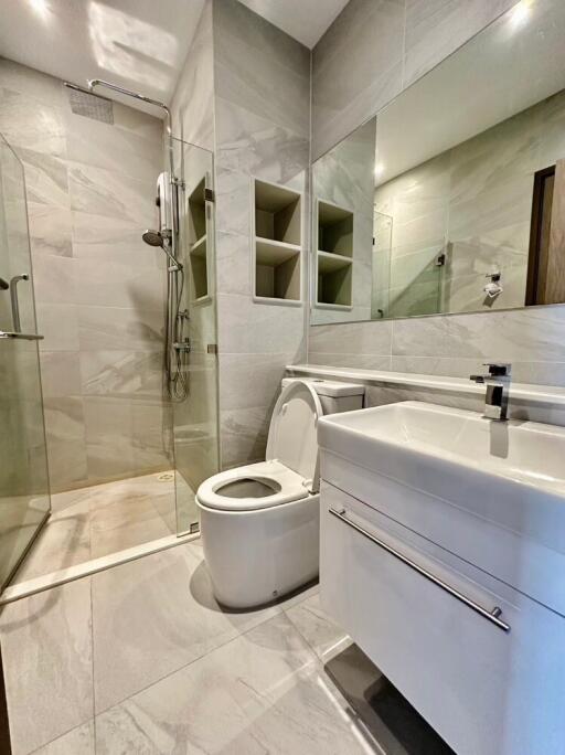 Modern bathroom with shower, toilet, and sink