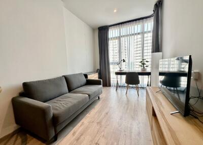 Modern living room with sofa, desk, and TV