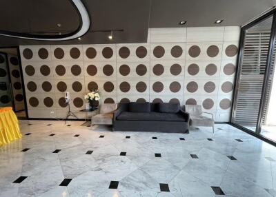 Modern living room with patterned wall and tiled floor