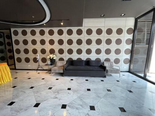 Modern living room with patterned wall and tiled floor