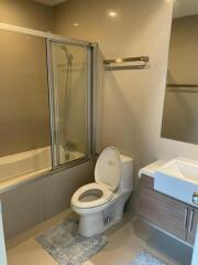 Modern bathroom with bathtub and shower combination, toilet, and sink