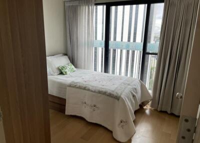 Bedroom with bed and large windows