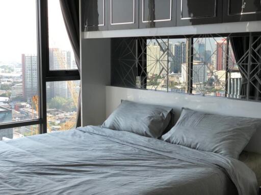 Modern bedroom with large window and city view