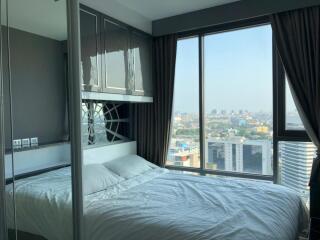 Modern bedroom with large windows and city view