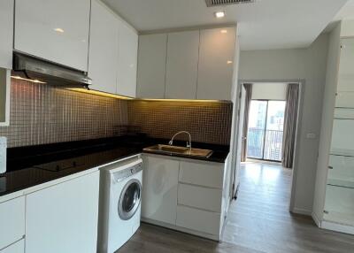 Modern kitchen with white cabinets and black countertop