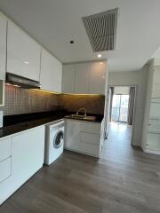 Modern kitchen with white cabinets and black countertop