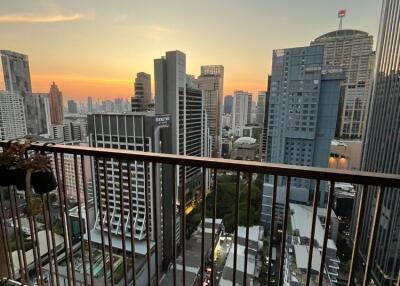 High-rise balcony with panoramic city view at sunset