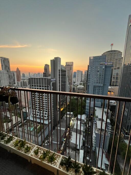 High-rise balcony with panoramic city view at sunset