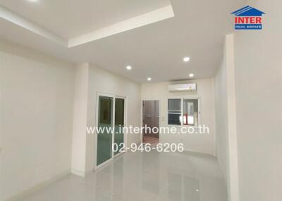 Spacious modern living room with recessed lighting and air conditioning