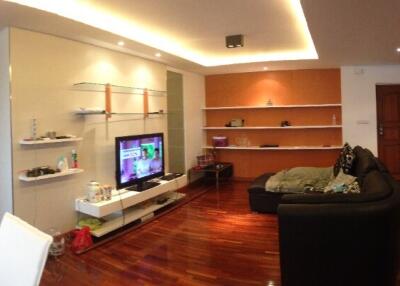 Modern living room with wooden flooring and shelves