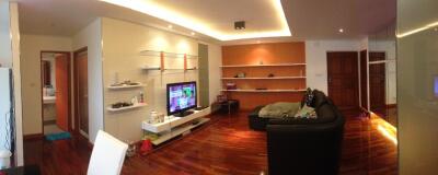 Modern living room with wooden flooring and shelves