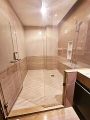 Modern bathroom with glass shower and tiled walls