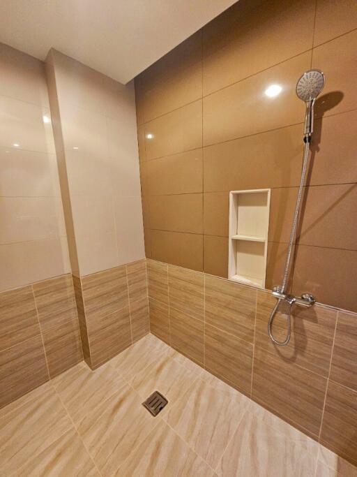 Bathroom with tiled walls and shower