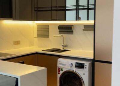 Modern kitchen with washing machine and built-in appliances