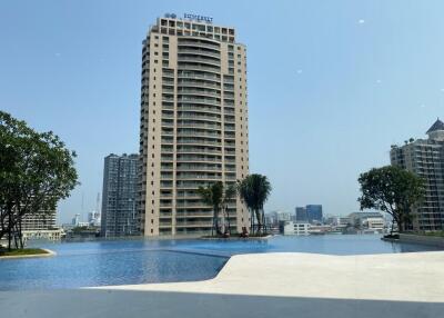 View of tall residential building with outdoor swimming pool