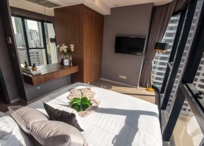 Modern bedroom with large windows and city view