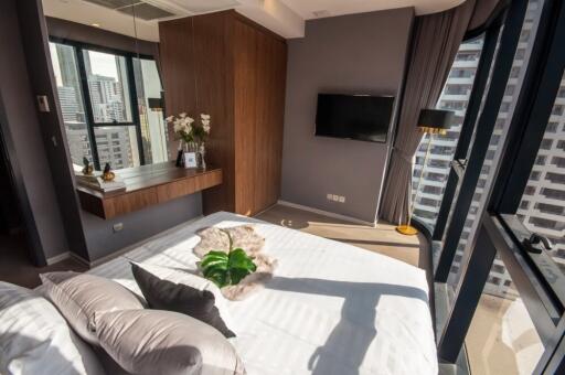 Modern bedroom with large windows and city view