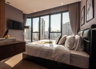 Modern bedroom with large windows and city view