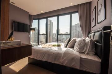 Modern bedroom with large windows and city view