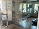 Gym with exercise equipment and natural light