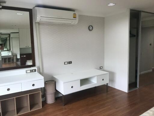 Bedroom with white furniture and wooden floor