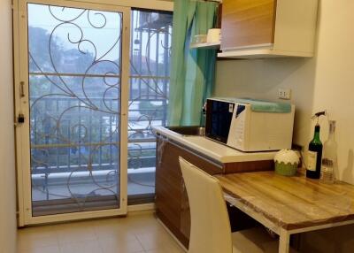 Small kitchen with dining area and balcony view