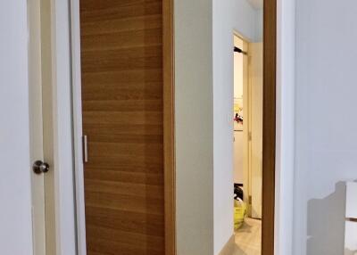 A bedroom with a wooden wardrobe and a mirror door