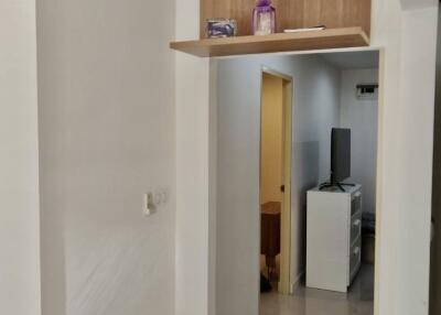 View of a hallway leading into a room with furniture