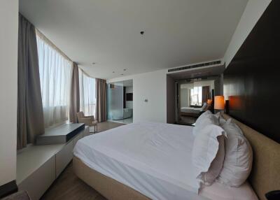 Spacious modern bedroom with large windows, double bed, and contemporary decor