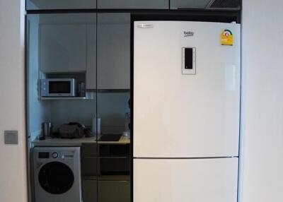 Modern kitchen with built-in appliances and reflective cabinets