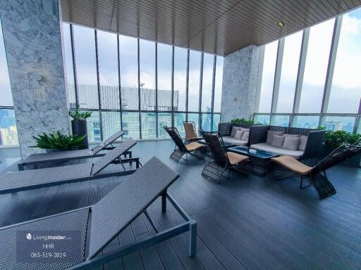 Modern outdoor lounge area with seating and city views