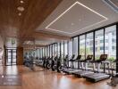 Modern gym with wooden flooring and large windows