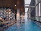 Luxurious indoor swimming pool area with lounge chairs and modern design