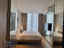 Modern bedroom with floor-to-ceiling windows and mirrored wardrobe