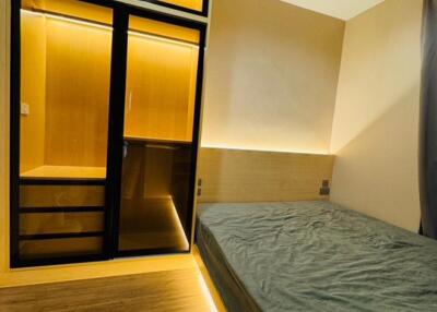 Modern bedroom with built-in wardrobe and cozy lighting